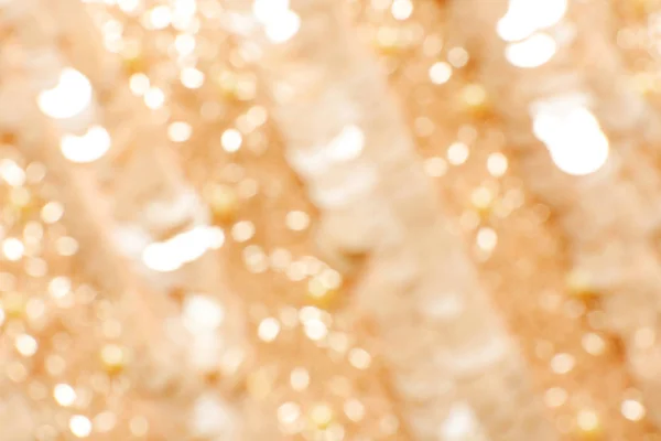 Blurred view of gold rose fabric with beautiful sequins as background — Stock Photo, Image