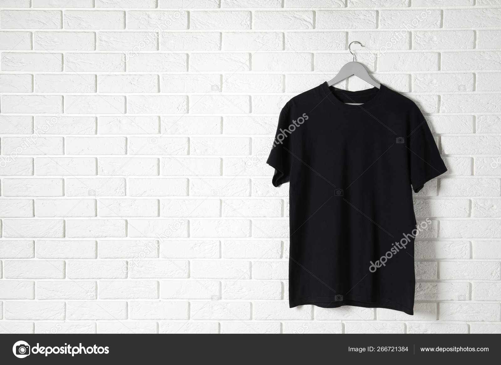 Download Hanger With Black T Shirt Against Brick Wall Mockup For Design Stock Photo Image By C Newafrica 266721384