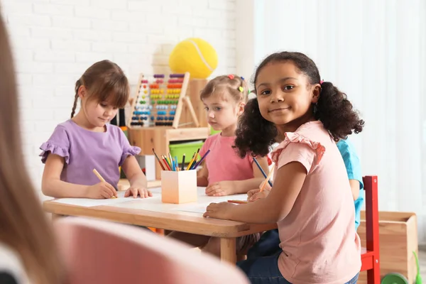 Adorable children drawing together at table indoors. Kindergarten playtime activities — Stock Photo, Image