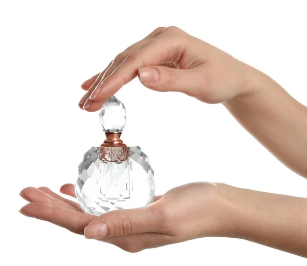 Woman holding bottle of luxury perfume on white background, closeup — 스톡 사진