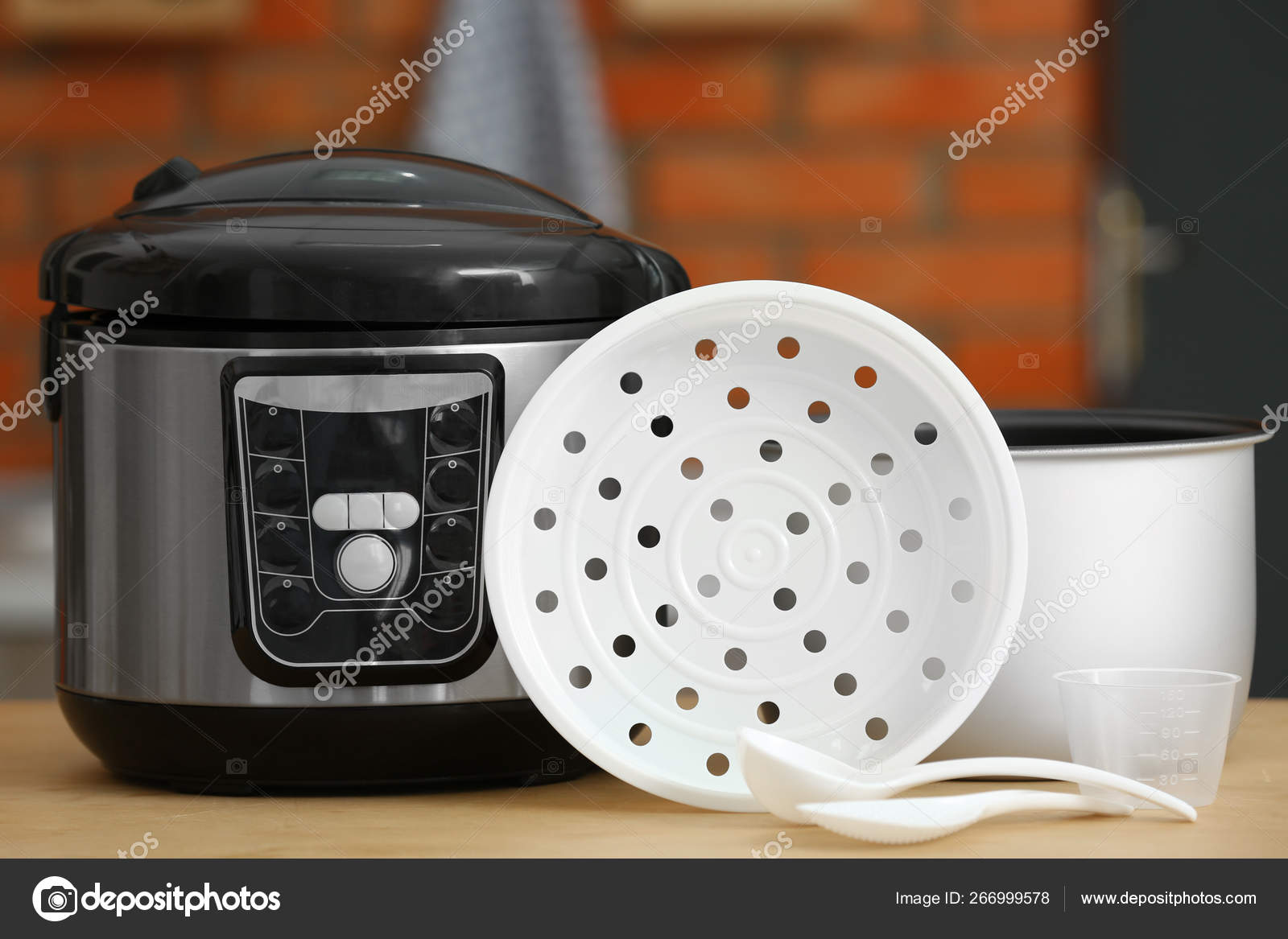 Modern electric multi cooker, parts and accessories on table in kitchen  Stock Photo by ©NewAfrica 266999578