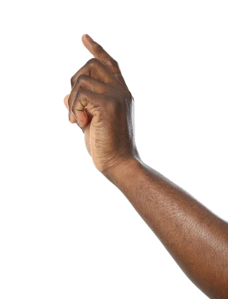 Afroameričan ukazuje na něco na bílém pozadí, v šatně — Stock fotografie