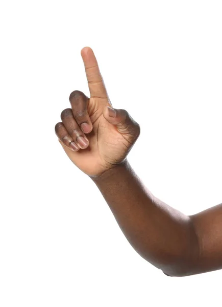Afrikanisch-amerikanischer Mann zeigt auf etwas auf weißem Hintergrund, Nahaufnahme — Stockfoto