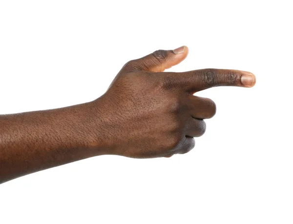 Afro-Amerikaanse man wijzend naar iets op witte achtergrond, close-up — Stockfoto