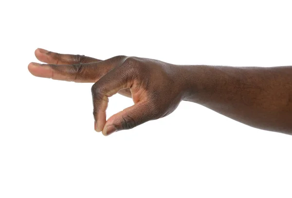 African-American man holding something in hand on white background, closeup — Stock Photo, Image