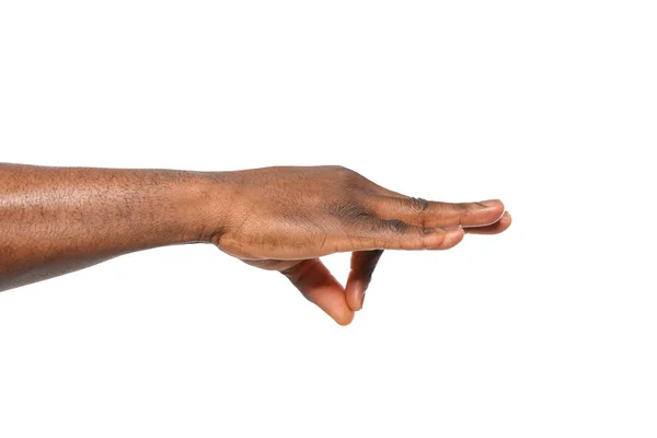 Afro-amerikai férfi gazdaság valamit a kezében, fehér háttér, Vértes — Stock Fotó