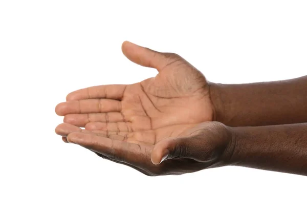 African-American man holding something in hands on white background, closeup — Stock Photo, Image