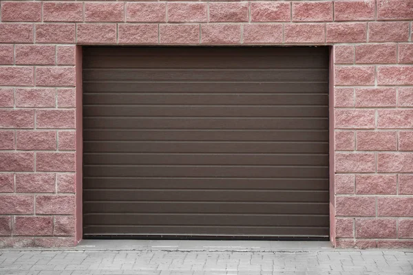Closed roller shutter door of modern garage