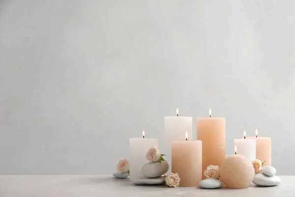 Hermosa composición con velas sobre la mesa sobre fondo gris. Espacio para texto — Foto de Stock