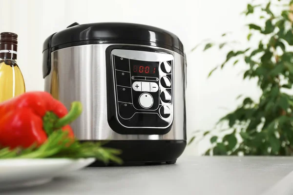 Modern multi cooker and products on kitchen table. Space for text — Stock Photo, Image