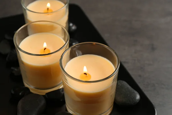 Dark plate with three burning candles on table. Space for text — Stock Photo, Image