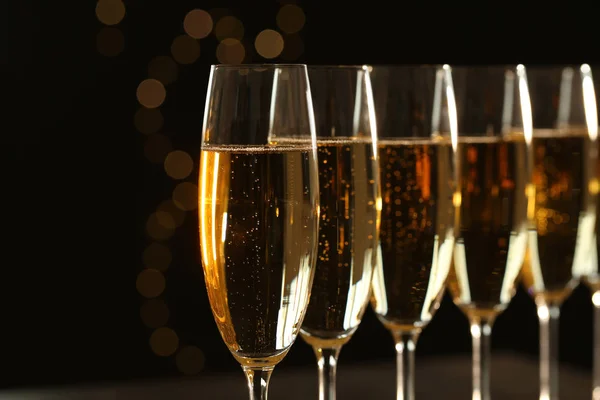 Glasses of champagne on blurred background, closeup. Space for text — Stock Photo, Image