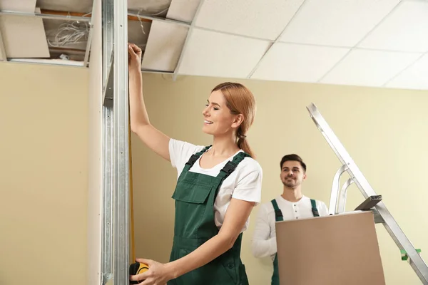 Workers installing drywall indoors. Home repair service — 스톡 사진
