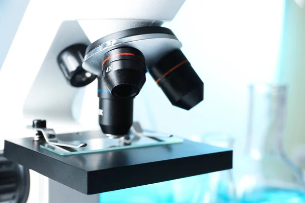 Closeup view of modern microscope with different lenses, space for text. Chemical research — Stock Photo, Image