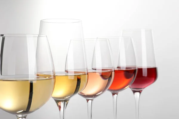 Row of glasses with different wines on white background — Stock Photo, Image