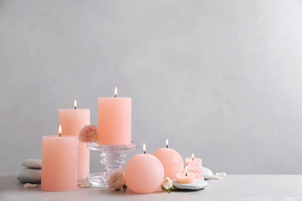 Beautiful composition with candles on table against grey background. Space for text — Stock Photo, Image