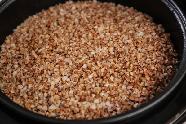 Delicious hot buckwheat in modern multi cooker, closeup — Stock Photo, Image