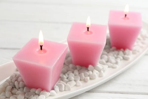 Composition with three burning candles on white wooden table — Stock Photo, Image