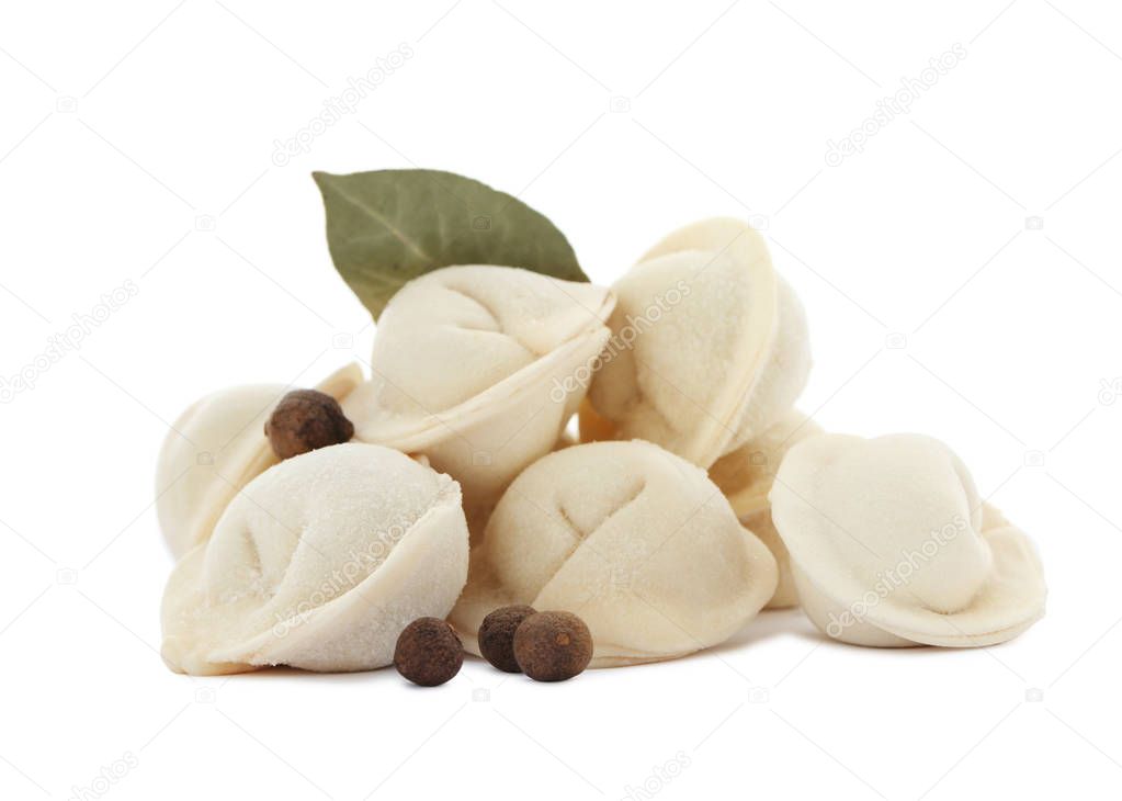 Raw meat dumplings with bay leaf and pepper on white background