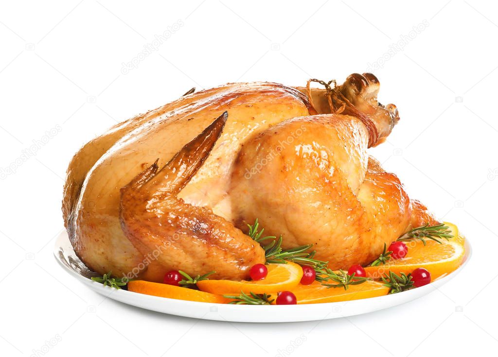Platter of cooked turkey with garnish on white background