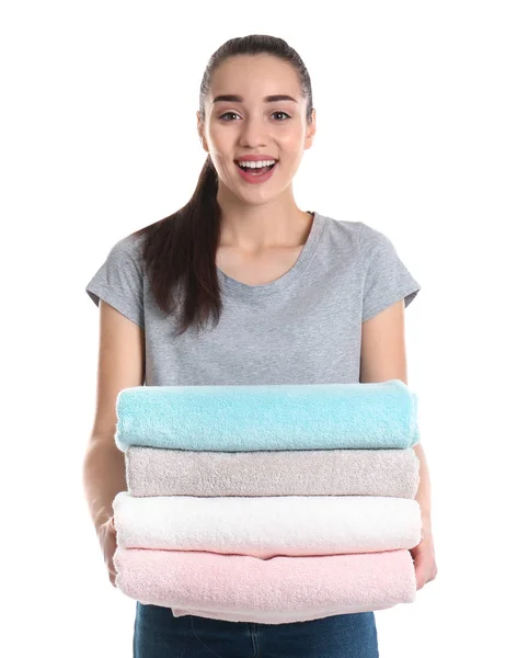 Happy young woman holding clean towels on white background. Laundry day — Stock Photo, Image