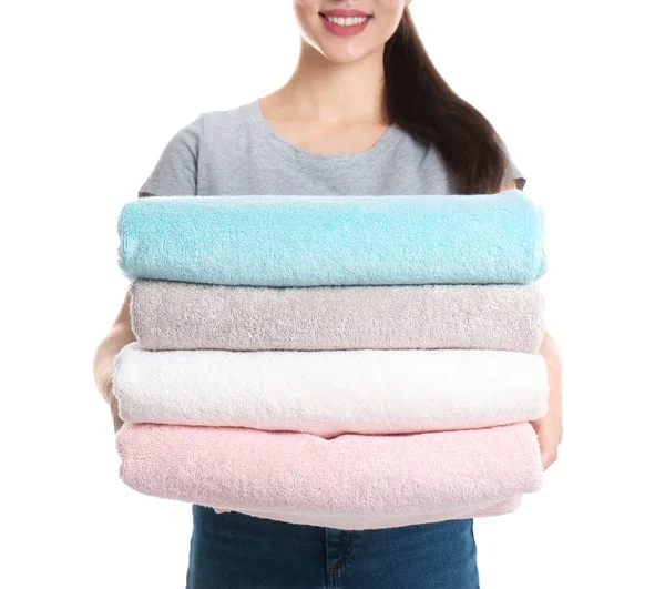 Young woman holding clean towels on white background, closeup. Laundry day — 스톡 사진