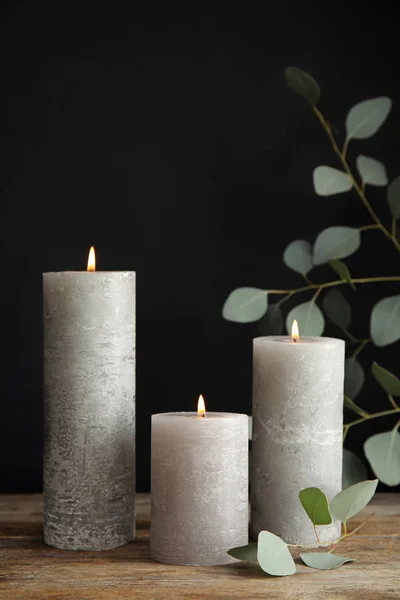 Composition avec des bougies allumées sur la table sur fond noir — Photo