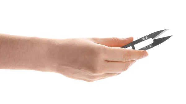 Woman holding pair of sewing scissors on white background, closeup — Stock Photo, Image