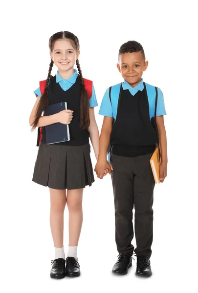 Retrato completo de niños lindos en uniforme escolar con libros sobre fondo blanco —  Fotos de Stock