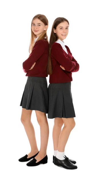 Retrato completo de chicas adolescentes en uniforme escolar sobre fondo blanco —  Fotos de Stock