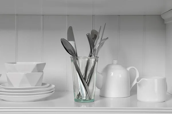 White shelving unit with dishware and cutlery — 스톡 사진