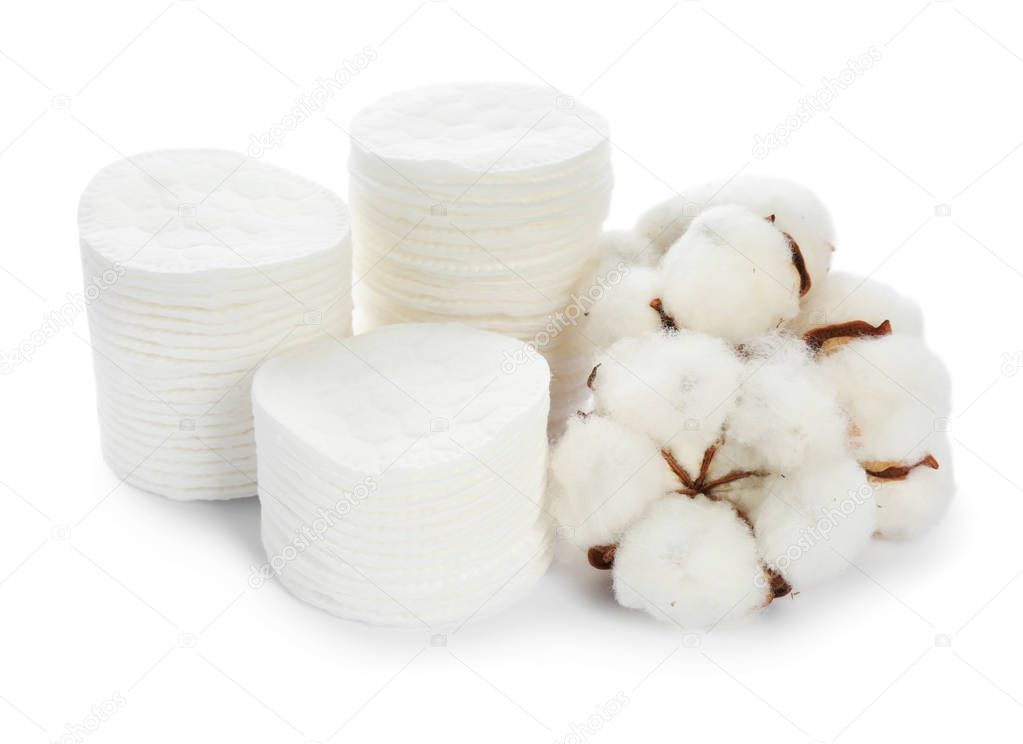 Composition with cotton pads and flowers on white background