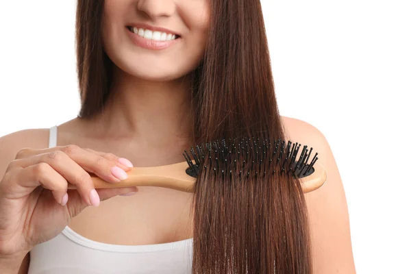 Woman with hair brush on white background, closeup — 스톡 사진