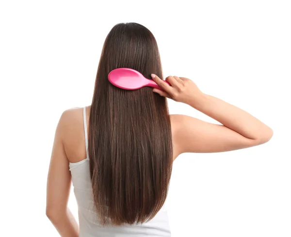 Back view of young woman with hair brush on white background — Stock Photo, Image