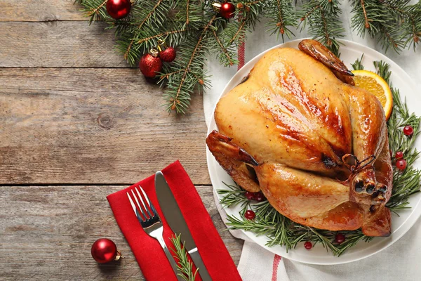 Cooked turkey with garnish served for Christmas dinner on table, flat lay. Space for text