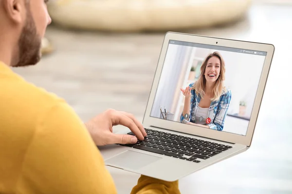 Young man using laptop for conversation with girlfriend via video chat at home, closeup — Stock Photo, Image