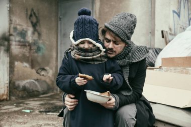 Çöplükte ekmek ile zavallı baba ve çocuk