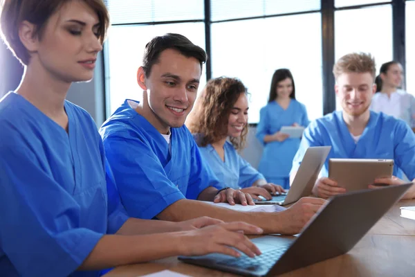 Gruppe intelligenter Medizinstudenten mit Gadgets im College — Stockfoto