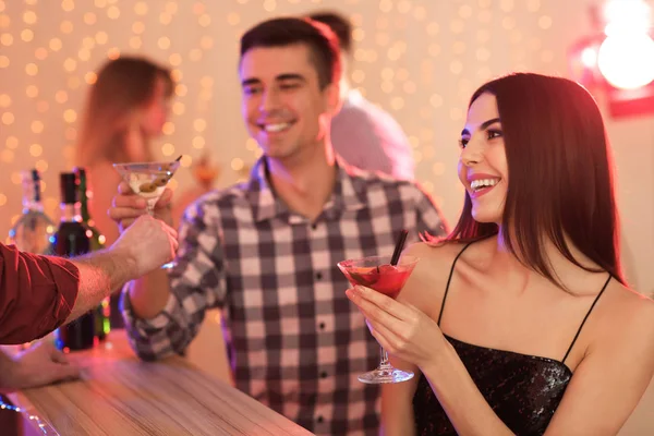 Young people with martini cocktails at party