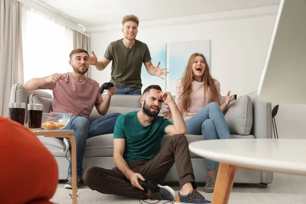 Emotional friends playing video games at home — Stock Photo, Image