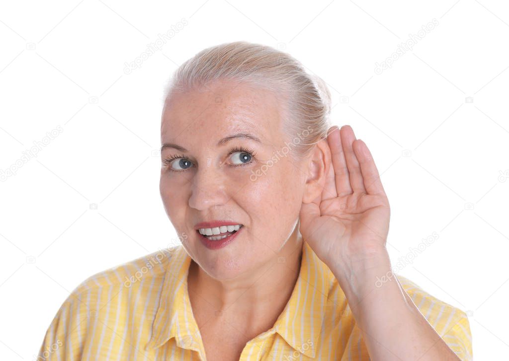 Mature woman with hearing problem on white background