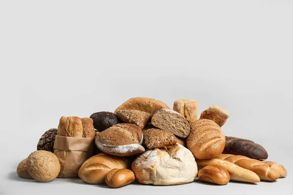 Куча свежего вкусного хлеба на светлом фоне — стоковое фото