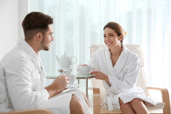 Romantic young couple with tea in spa salon — Stock Photo, Image