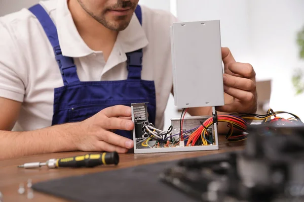 Técnico masculino reparando la unidad de fuente de alimentación en la mesa, primer plano —  Fotos de Stock