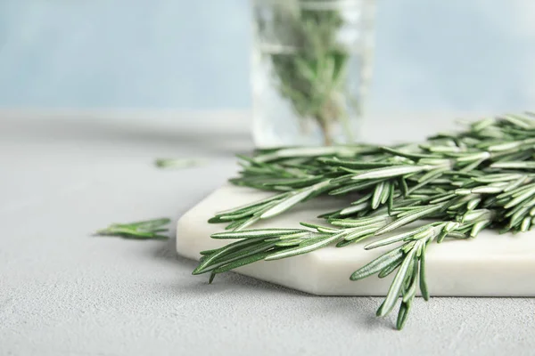 Tavola con ramoscelli di rosmarino verde fresco sul tavolo. Spazio per testo — Foto Stock