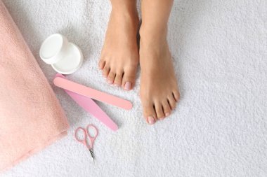 Beyaz havlu, metin için alan güzel ayakları ve pedikür aksesuarları ile kadın üst görünümü. Spa tedavisi