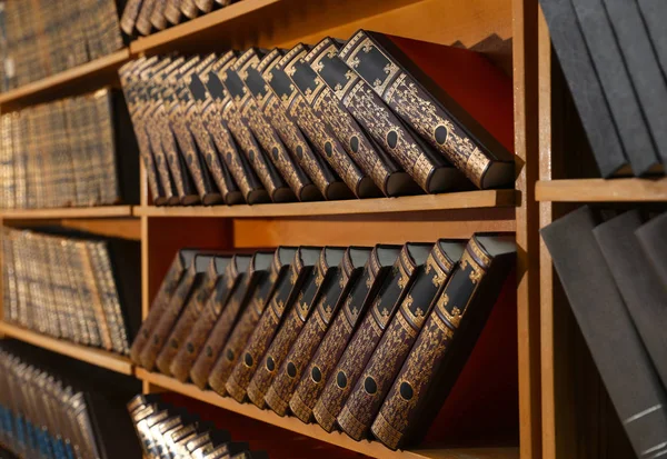 Wooden cabinets with collection of books in library — 스톡 사진