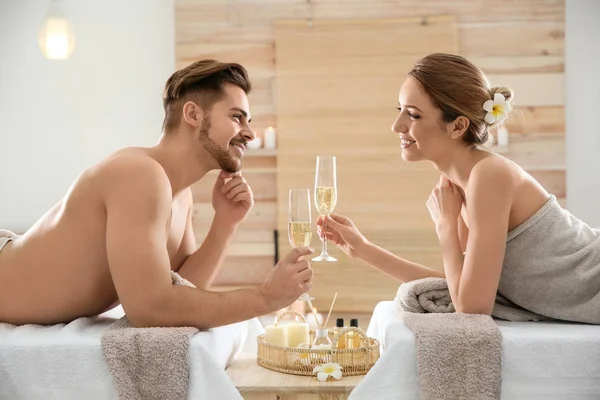 Romântico jovem casal com champanhe no salão de spa — Fotografia de Stock