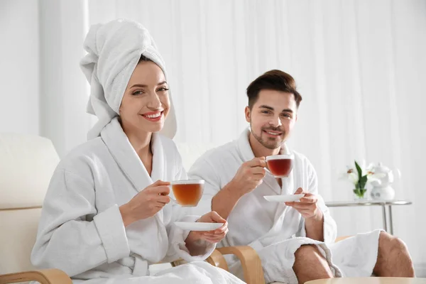 Romantic young couple with tea in spa salon — Stock Photo, Image