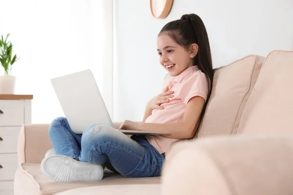 Little girl using video chat on laptop at home — Stock Photo, Image